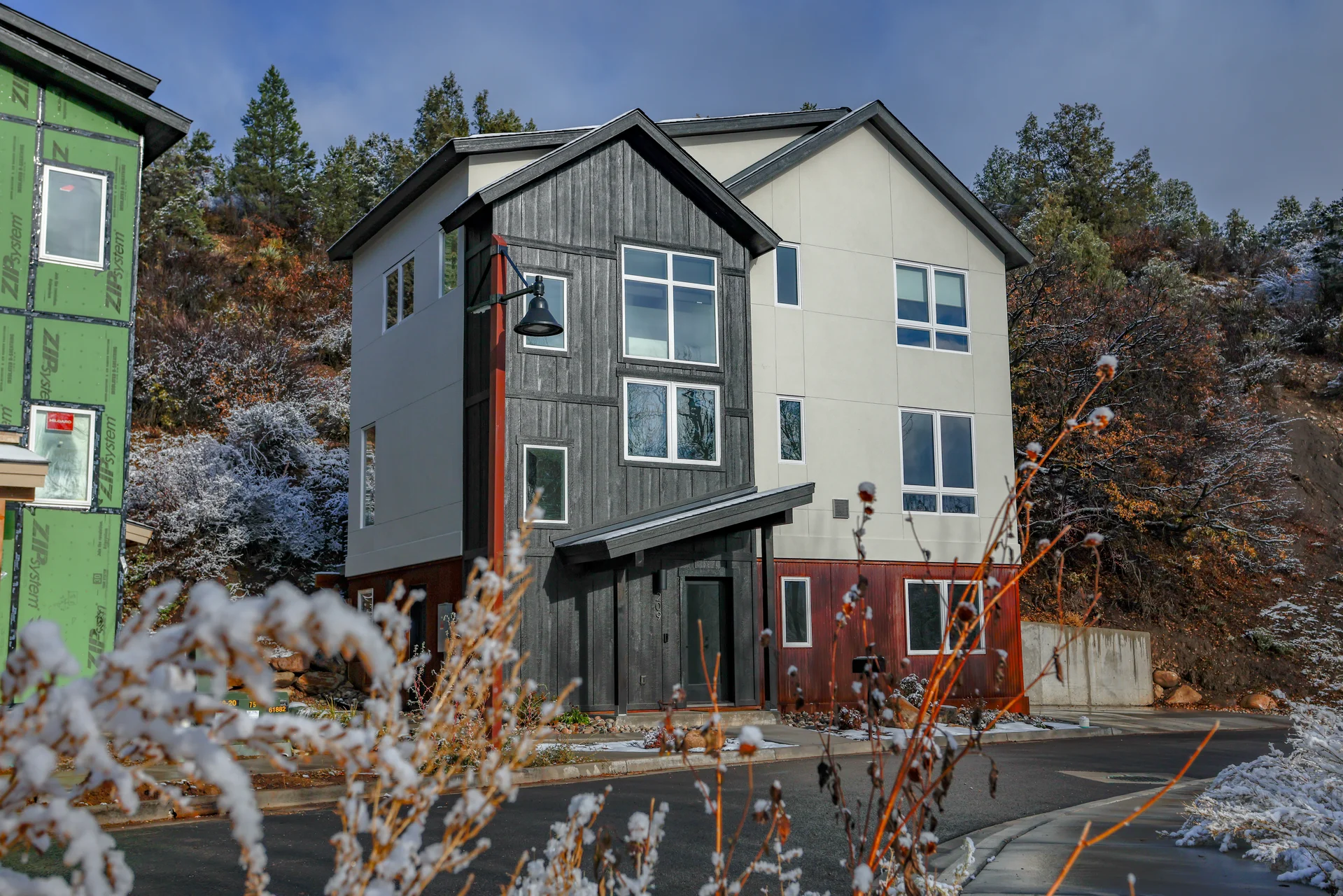 Modern exterior with mixed materials and mountain backdrop